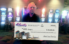 Jackpot winner Craig L. holding a check